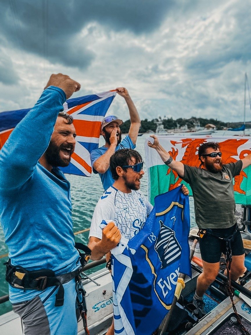 The Ocean Revival crew celebrating a crossing with flags raised