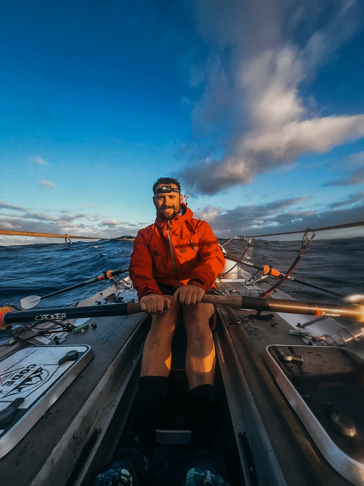 Skipper Matt Mason rowing at dawn under a dramatic sky